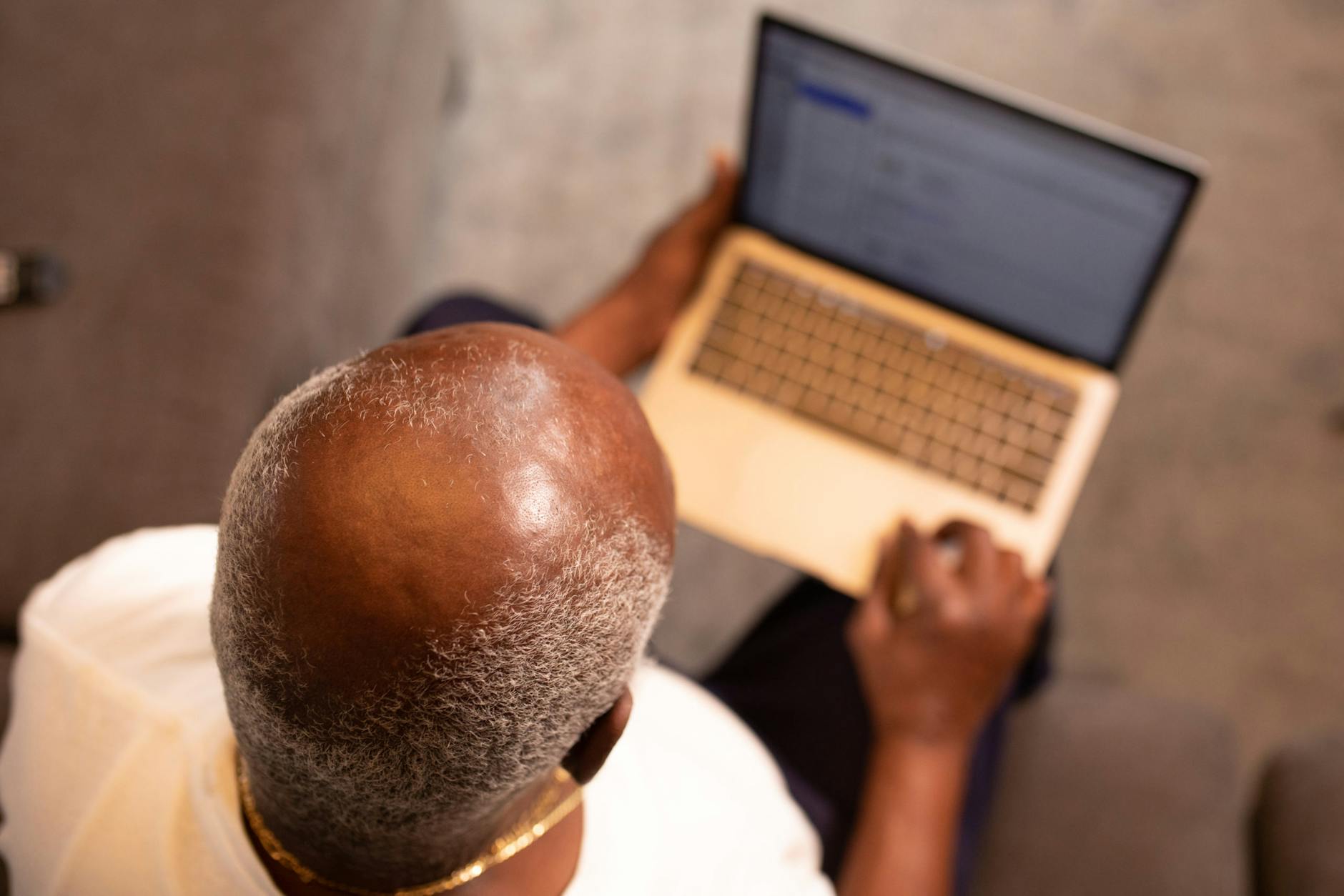 man in white shirt using macbook pro