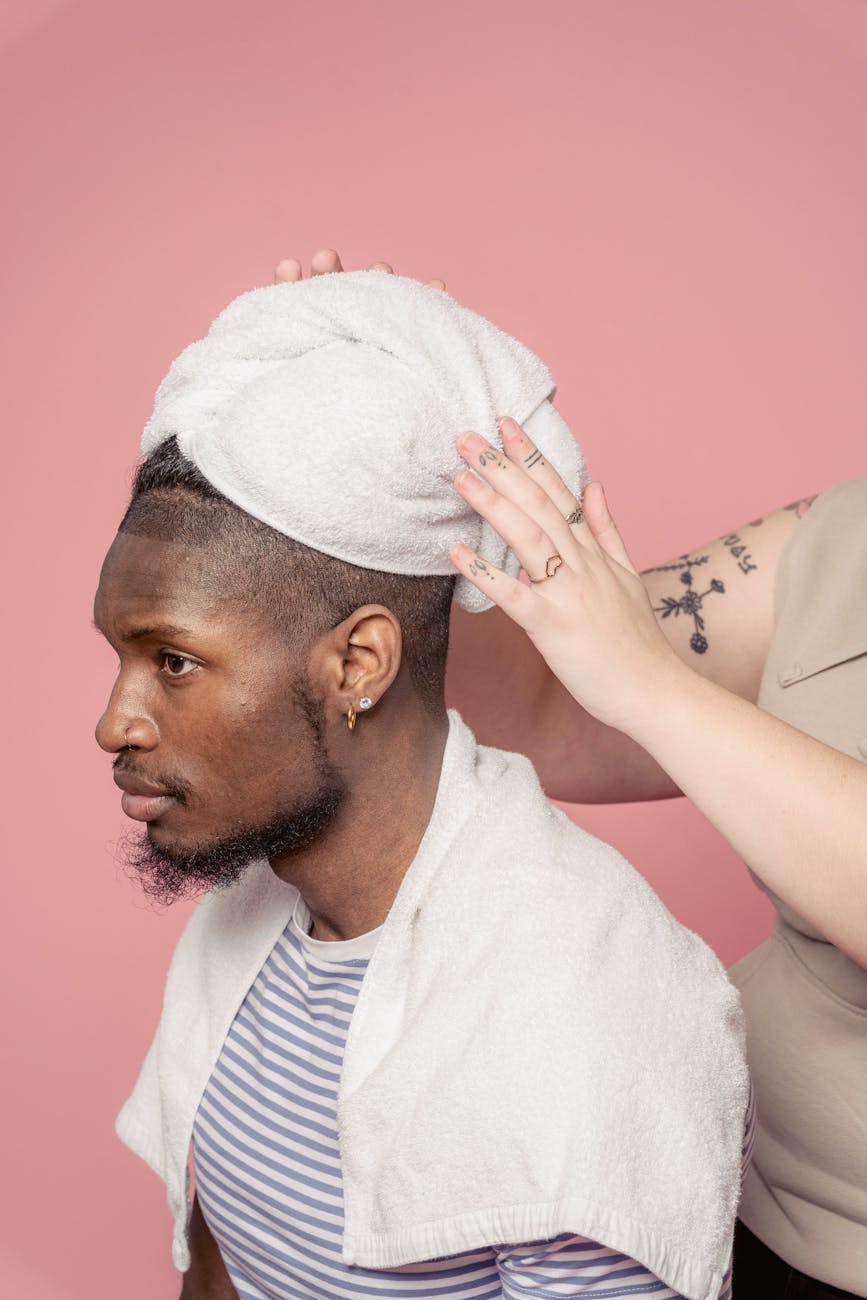 black man with towel on head in salon